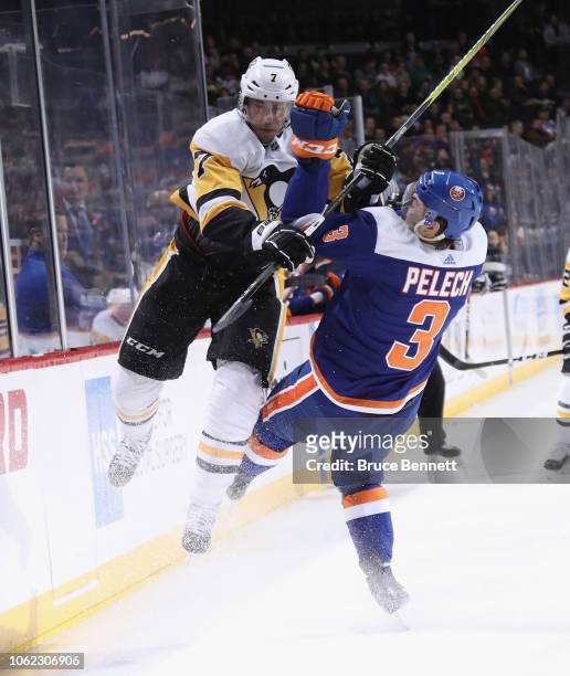 Matt Cullen of the Pittsburgh Penguins checks Adam Pelech of the New York Islanders during the first period at the Barclays Center on November 01,...