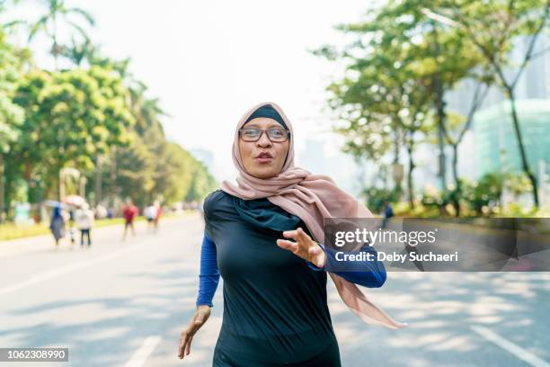 marathon runner and cancer survivor - daily life in indonesia stock pictures, royalty-free photos & images