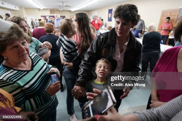 Democratic U.S. House of Representatives candidate for Kentucky Amy McGrath and her six-year-old son Teddy Henderson greet supporters at a community...