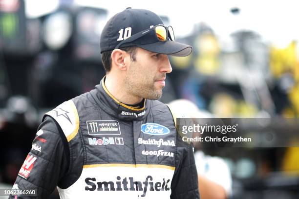 Aric Almirola, driver of the Smithfield Ford, stands in the garage area during practice for the Monster Energy NASCAR Cup Series Ford EcoBoost 400 at...