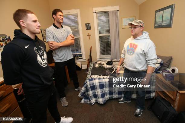 Brook Lopez and Donte DiVincenzo of the Milwaukee Bucks interact with veterans while preparing dinner and playing board games on November 11, 2018 at...