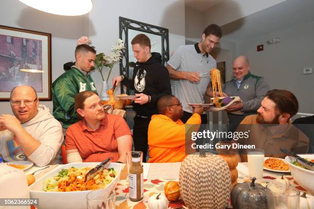 Brook Lopez and Donte DiVincenzo of the Milwaukee Bucks interact with veterans while preparing dinner and playing board games on November 11, 2018 at...