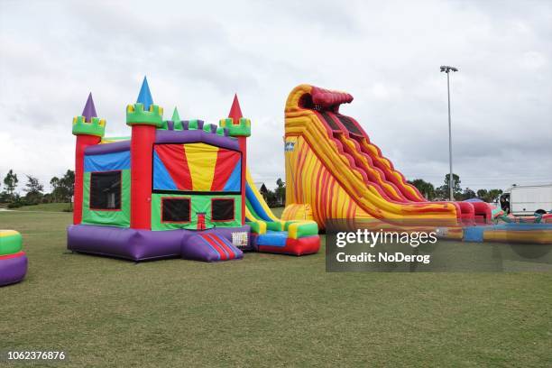 bounce houses at a public park - bouncy castle stock pictures, royalty-free photos & images