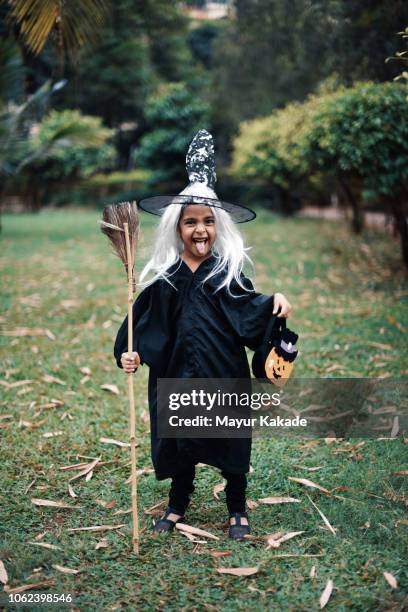 girl dressed as a witch on the halloween day - witch costume stock pictures, royalty-free photos & images