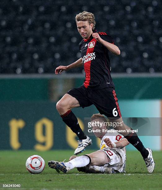 Simon Rolfes of Leverkusen and Marco Reus of Gladbach battle for the ball during the DFB Cup match between Borussia M'gladbach and Bayer Leverkusen...