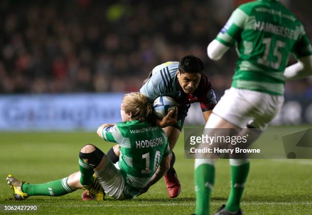 Joel Hodgson of Newcastle Falcons suffers a leg injury while tackling Ben Tapuai of Harlequins during the Gallagher Premiership Rugby match between...