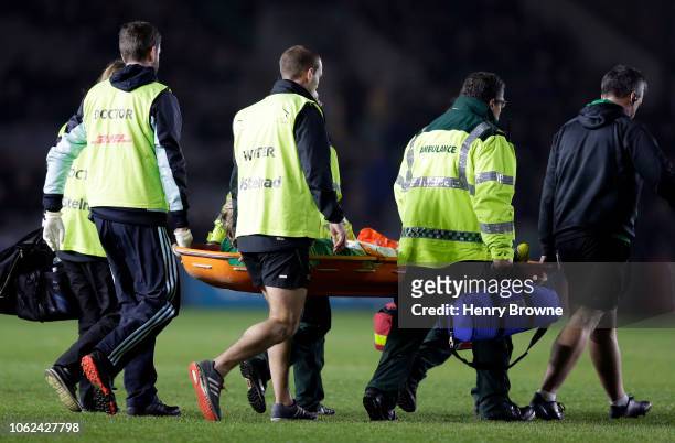 Joel Hodgson of Newcastle Falcons is stretched off the pitch after suffering a leg injury while tackling Ben Tapuai of Harlequins during the...