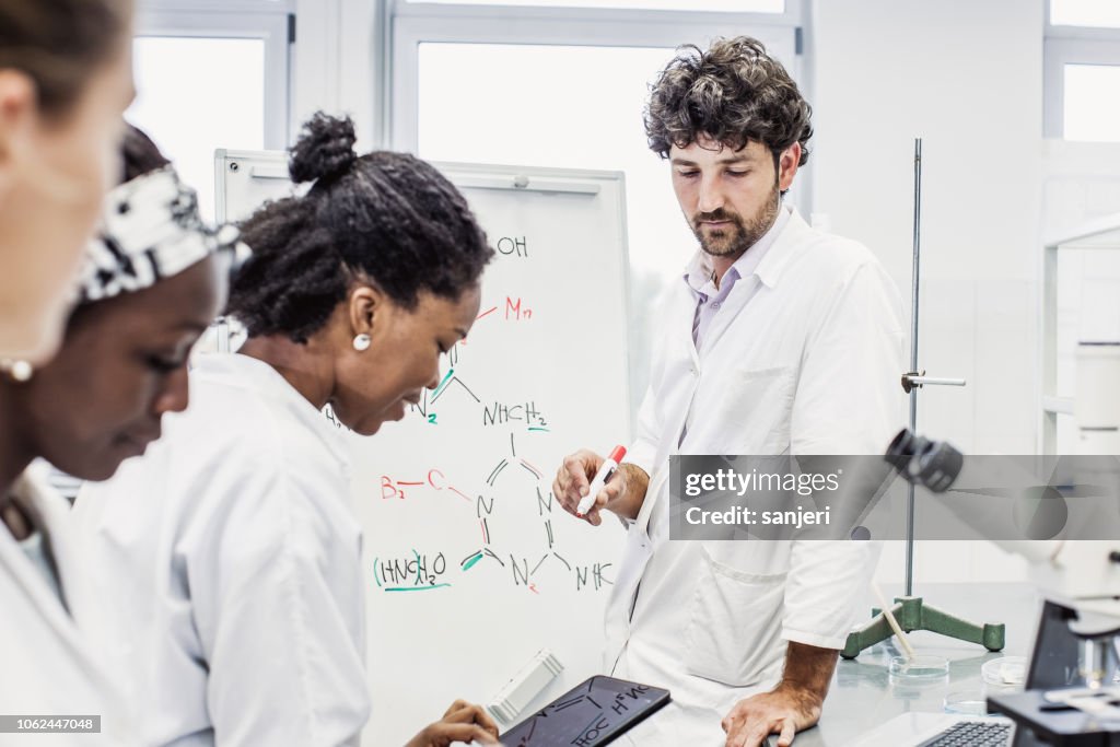 Scientist Having A Discussion Meeting In The Laboratory High-Res Stock ...