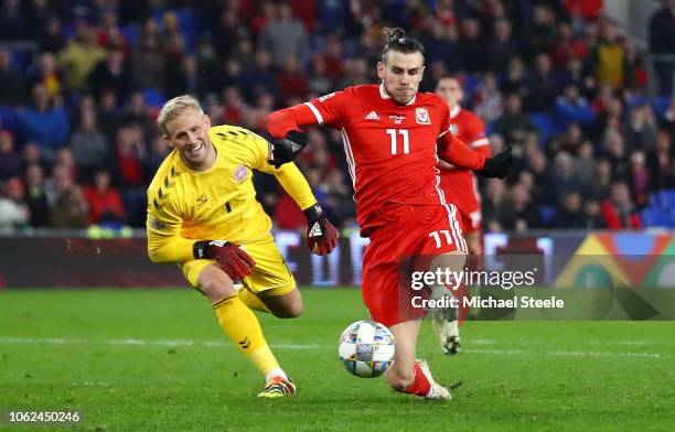 Martin Braithwaite of Denmark scores his team's first goal past Kasper Schmeichel of Denmark during the UEFA Nations League Group B match between...