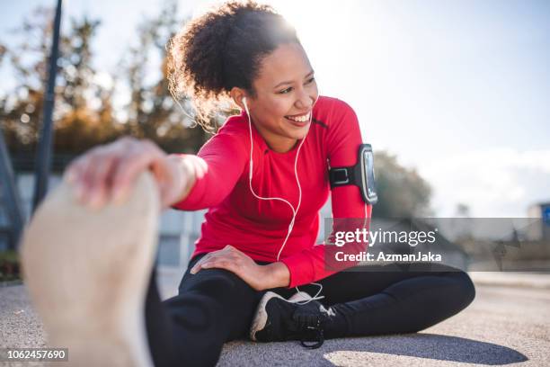 woman stretching - black shoe imagens e fotografias de stock