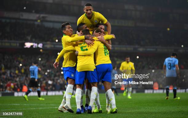 Neymar da Silva Santos Jnior of Brazil celebrates with teammates after scoring the opening goal from the spot during the International Friendly...