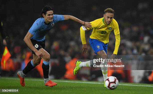 Neymar da Silva Santos Jnior of Brazil gets past Edinson Cavani of Uruguay during the International Friendly between Brazil and Uruguay at Emirates...