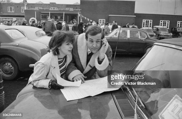 British actors Janet Munro and Ian Hendry at a showbiz car rally, UK, 4th February 1963.