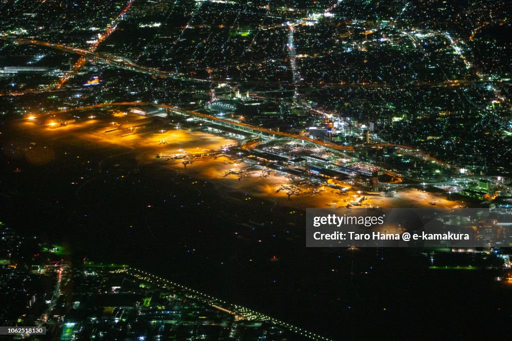 Osaka International Airport Itami (ITM) in Japan night time aerial view from airplane