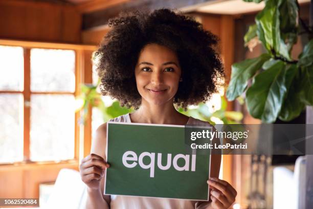 young woman stands for equal rights. - discrimination stock pictures, royalty-free photos & images