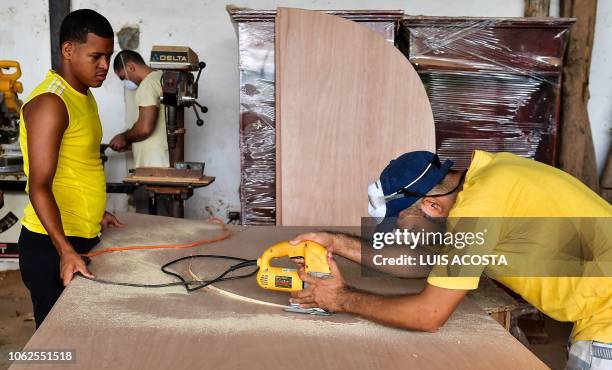 Inmates at La Joya prison work in the production of 250 confessionals for the upcoming World Youth Day Panama, on November 13, 2018 in Panama City. -...