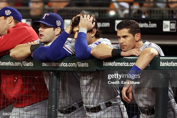 Michael Young and Ian Kinsler of the Texas Rangers look on from the dugout against the San Francisco Giants in Game One of the 2010 MLB World Series...