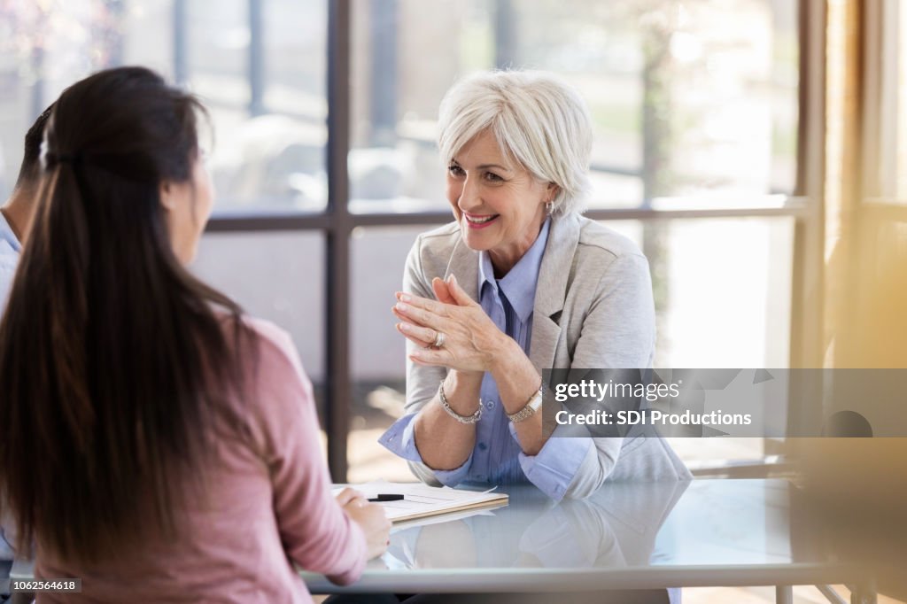 Cheerful counselor works with married couple