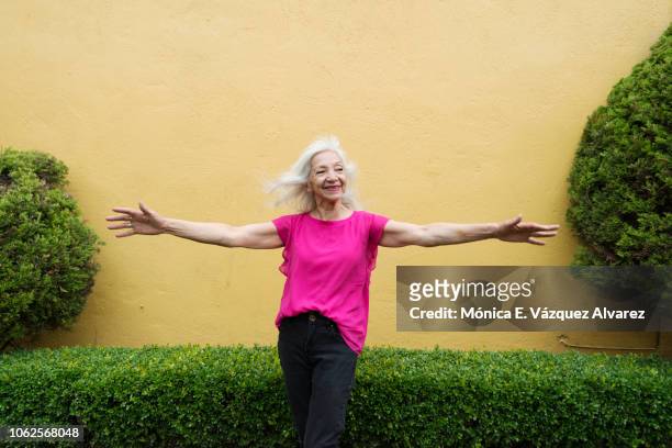 Mature woman posing in a garden