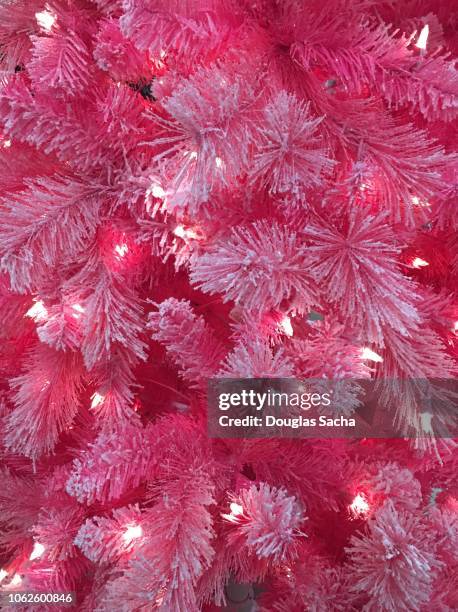 neon pink colored christmas tree - lametta stock-fotos und bilder