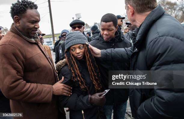 The Rev. Michael Pfleger, right, along with other clergy, talk with Avontea Boose, the mother of Jemel Roberson's son, outside the Midlothian Police...