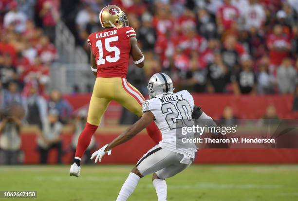 Pierre Garcon of the San Francisco 49ers catches a pass in front of Daryl Worley of the Oakland Raiders during the first half of their NFL football...