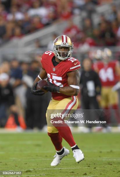 Pierre Garcon of the San Francisco 49ers runs with the ball after catching a pass against the Oakland Raiders during the first half of their NFL...