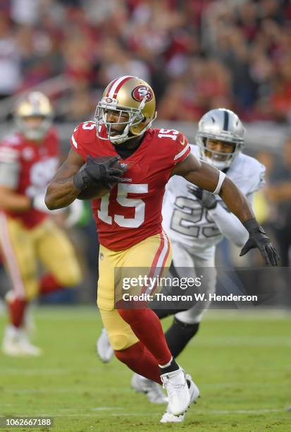 Pierre Garcon of the San Francisco 49ers runs with the ball after catching a pass against the Oakland Raiders during the first half of their NFL...