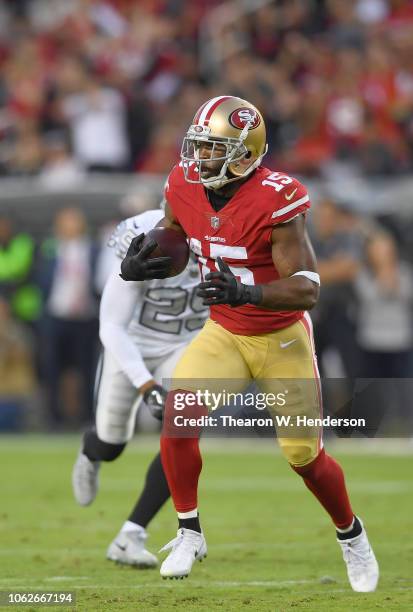 Pierre Garcon of the San Francisco 49ers runs with the ball after catching a pass against the Oakland Raiders during the first half of their NFL...