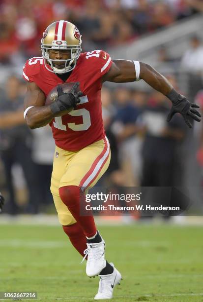 Pierre Garcon of the San Francisco 49ers runs with the ball after catching a pass against the Oakland Raiders during the first half of their NFL...