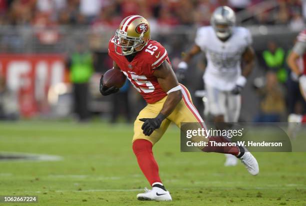 Pierre Garcon of the San Francisco 49ers runs with the ball after catching a pass against the Oakland Raiders during the first half of their NFL...