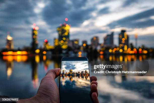 vienna donaucity on smartphone display - austria skyline stock pictures, royalty-free photos & images