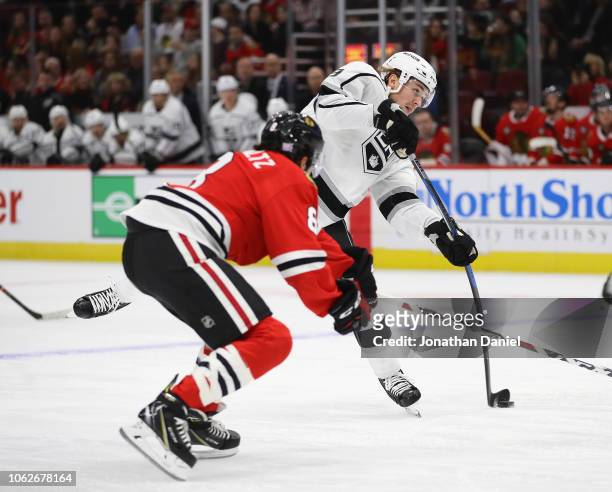 Adrian Kempe of the Los Angeles Kings fires a shot past Nick Schmaltz of the Chicago Blackhawks at the United Center on November 16, 2018 in Chicago,...