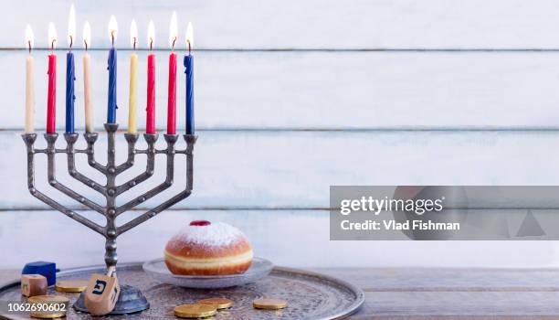 sufgania, dreidels, menorah ,hanukkah coins or hanukkah gelt. wood background. translation: p - chocolate gelt stockfoto's en -beelden