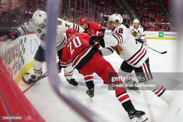 Chicago Blackhawks Left Wing Alex DeBrincat cross checks Carolina Hurricanes Center Sebastian Aho during a game between the Chicago Blackhawks and...