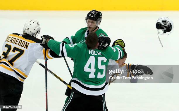 Patrice Bergeron of the Boston Bruins fight with Esa Lindell of the Dallas Stars as Torey Krug of the Boston Bruins fights with Roman Polak of the...