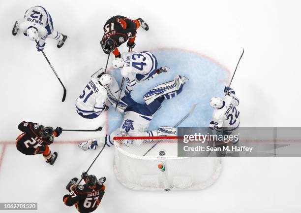 Ondrej Kase, Ryan Getzlaf and Rickard Rakell of the Anaheim Ducks poke at a loose puck as Garret Sparks, Jake Gardiner, Nikita Zaitsev and Patrick...