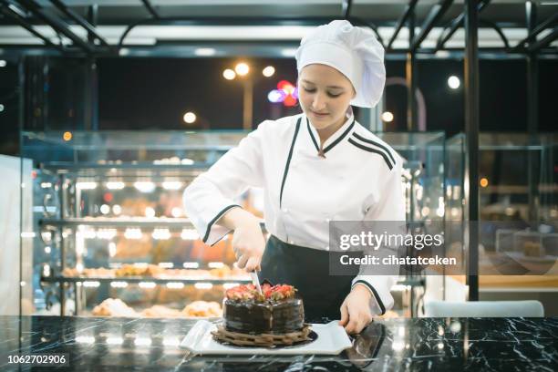 chef woman cutting pastry - confectioner stock pictures, royalty-free photos & images