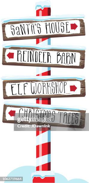 christmas themed wooden winter sign with hand lettered text - elf workshop stock illustrations