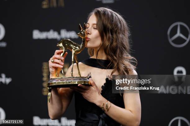 Paula Beer, wearing Chanel, poses with award during the 70th Bambi Awards winners board at Stage Theater on November 16, 2018 in Berlin, Germany.