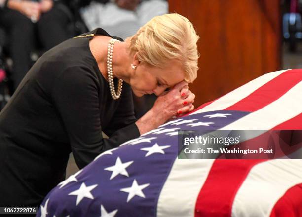 Cindy McCain, wife of late-Sen. John S. McCain says a prayer at his casket as he lies in state during a ceremony to honor the six-term senator from...