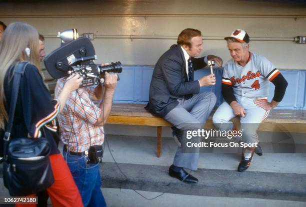 Manager Earl Weaver of the Baltimore Orioles sits in the dugout being interviewed prior to the start of an Major League Baseball game circa 1985....