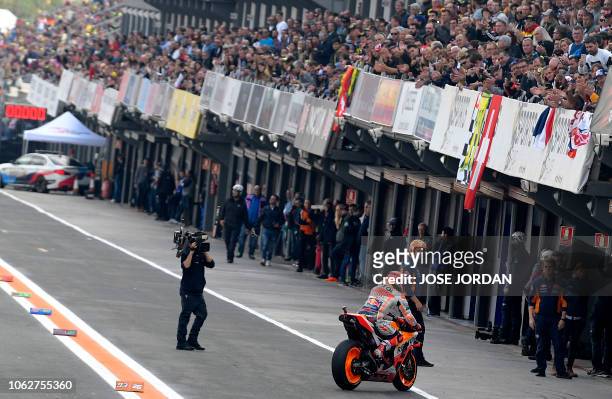 Repsol Honda's Spanish rider Marc Marquez returns to the pit after the MotoGP qualifying session of the Valencia Grand Prix at the Ricardo Tormo...