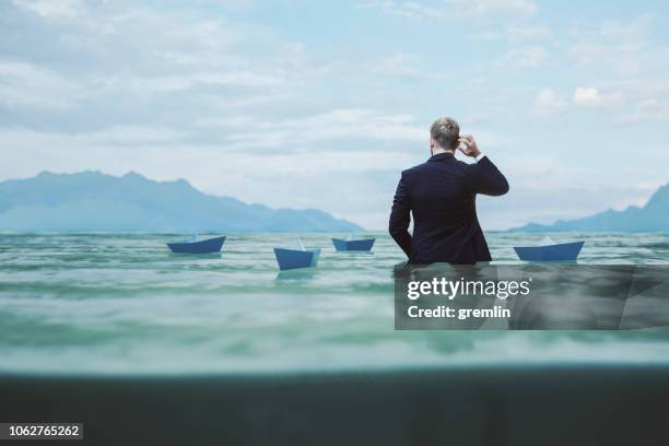 lost and confused businessman in water - business humor stock pictures, royalty-free photos & images