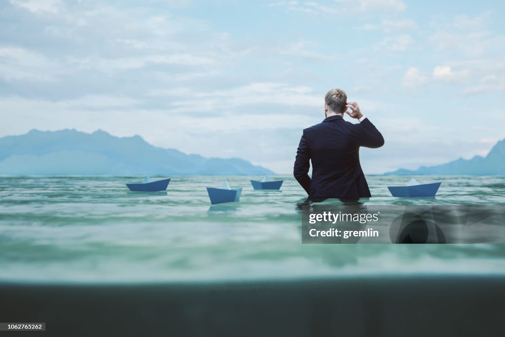 Lost and confused businessman in water