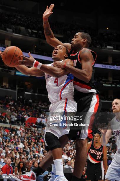 Randy Foye of the Los Angeles Clippers has his shot challenged by Marcus Camby of the Portland Trail Blazers at Staples Center on October 27, 2010 in...