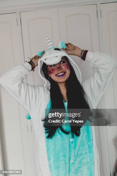 portrait of young brunette in unicorn  hooded onesie - babygro stock pictures, royalty-free photos & images