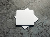 Two White beer coasters Mockup on the concrete floor