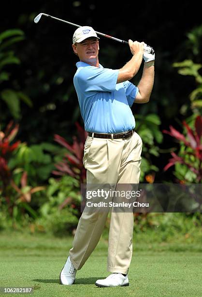 Ernie Els of South Africa watches his 2nd shot on the 1st tee during day one of the CIMB Asia Pacific Classic at The MINES Resort & Golf Club on...