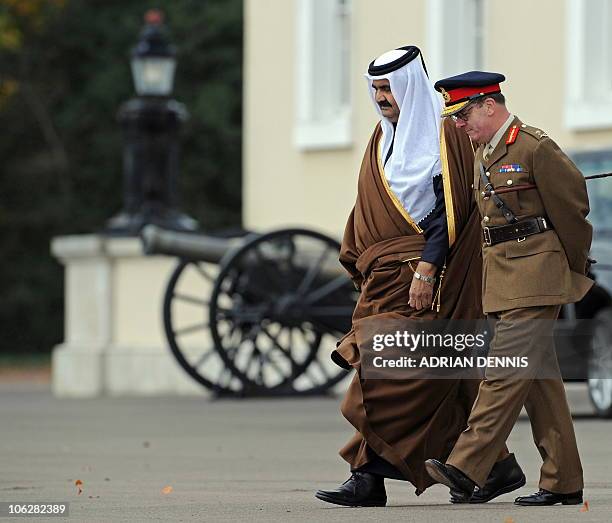 Qatar's Emir, Sheikh Hamad bin Khalifa al-Thani , walks accross the Parade Ground with Commandant General Marriot, as he arrives The Royal Military...